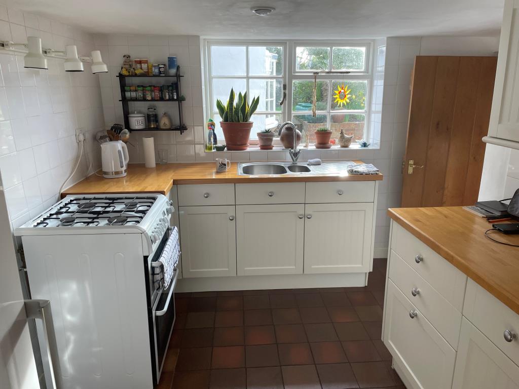 Lot: 101 - CHARACTER COTTAGE IN FAVOURED LOCATION - View of fitted kitchen with access to front entrance
